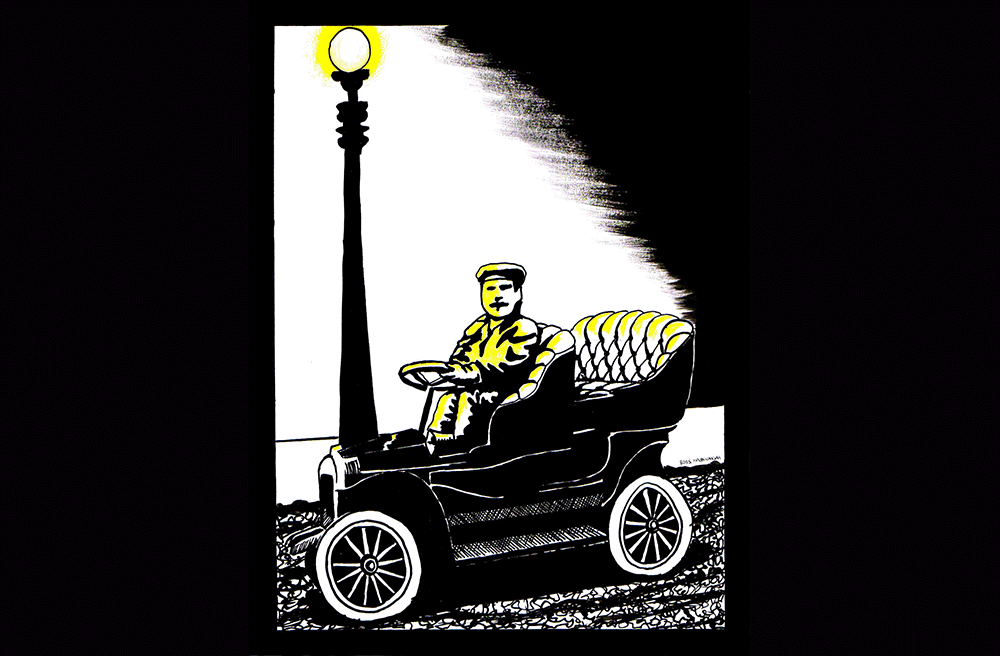 A man in an old car by a streetlight / Un homme dans une vieille voiture près d'un réverbère